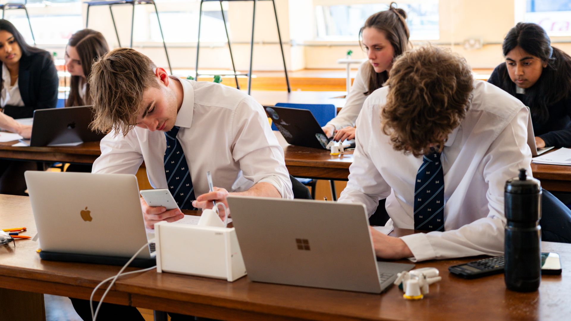 Reigate Grammar School students working together with technology in class